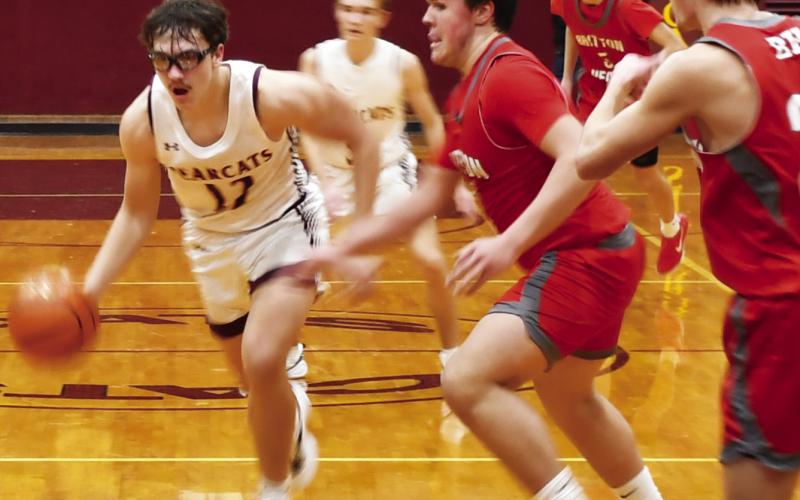 Webster Area Bearcats boys basketball took on the Britton-Hecla Braves Dec. 20 in a contest the Bearcats lost 46-56. Here, Webster Area forward Jeron McCreary (12) drives to the paint with Britton-Hecla defenders Graham Fosness (15) and Daniel Person (20) attempting to impede his route to the basket. Reporter &amp;amp; Farmer | Brenner Cariveau