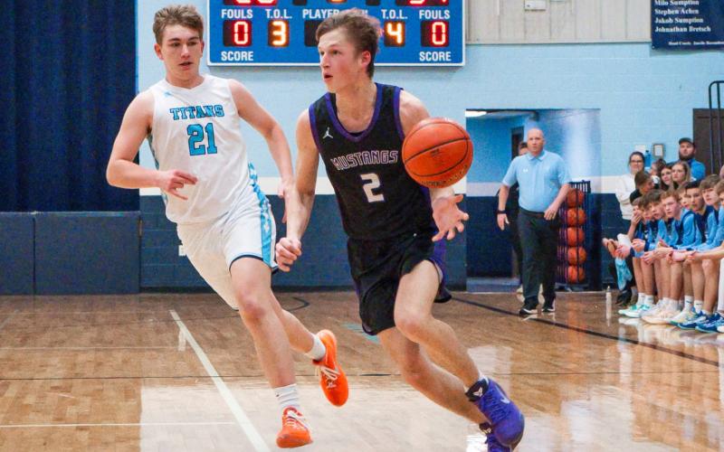 Evan Aker (2) of Waubay/Summit drives past Winston Clark (21) of Leola/Frederick Titans during the Mustangs 56-66 loss March 6 in Frederick. Aker scored four points as Waubay/Summit ended their season with a record of 15-7. Reporter &amp;amp; Farmer | Leyton Beardslee