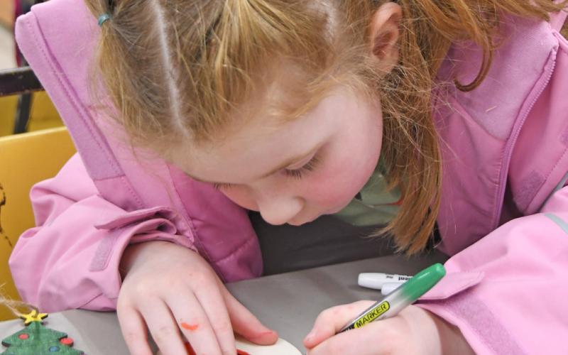 Reporter &amp;amp; Farmer Amanda Dulitz At right Four-year-old Iyla Warner colors a wooden Christmas tree ornament Dec. 1 at the Day County Arts Center in Webster during a community event held there. Warner is the daughter of Mia Hannan and Cody Warner.