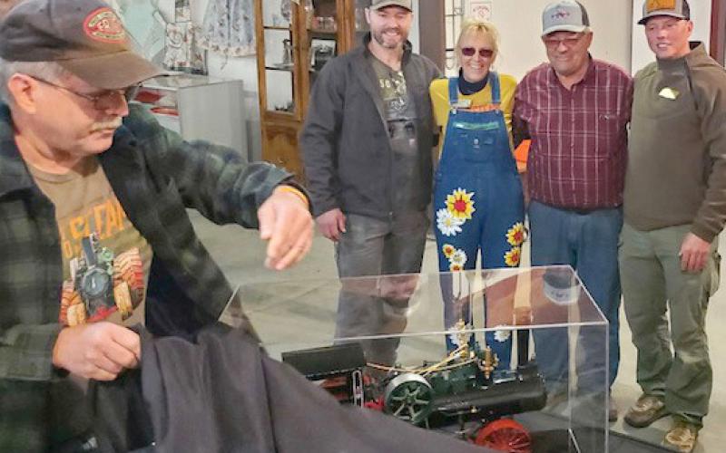 Sam Hoffman, left, from Elizabethtown, PA unveils a built-from-scratch 110 Case steam engine with working parts, for Scott Anderson’s 40th birthday. The engine took 1,000 hours to build. Hoffman regularly sets up his display at the James Valley Threshing show. Pictured, from right, are recipient Scott and his family Kevin, Donna and Kory Anderson. Reporter &amp;amp; Farmer | Subscriber snapshot