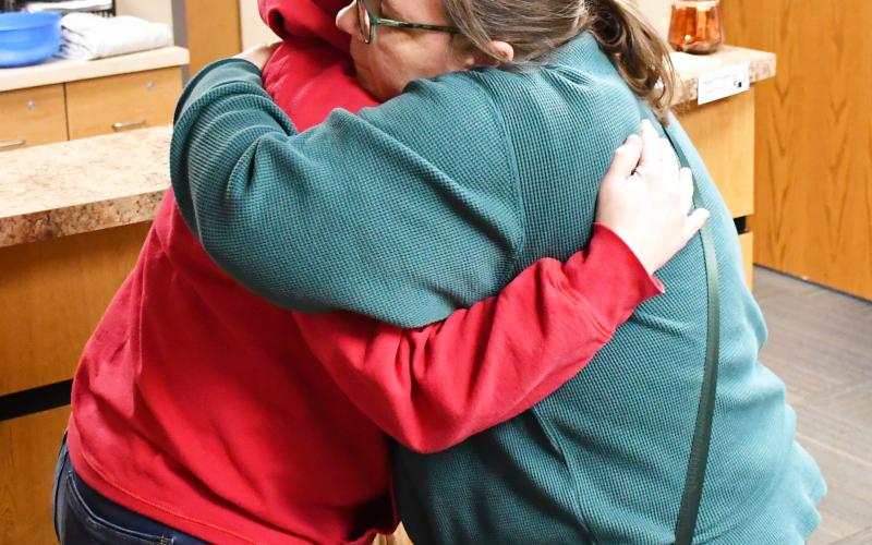 An anonymous citizen purchased a jacket at Ace Hardware Feb. 6 for Webster Area School crossing guard Annette Duarte after they saw her in the cold without the proper attire. Once the jacket was purchased, the good Samaritan asked Ace Hardware owner Shannon Garduno to drop the jacket off at the school for Duarte. Here, Garduno embraces Duarte after the jacket was presented. See more on page 6. Reporter &amp;amp; Farmer | Brenner Cariveau