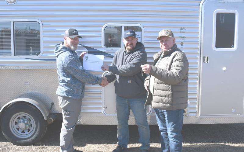 Izaak Walton League donated an ice shack to be used by veterans as a part of the Patriot House Project March 11. Here from left, Veterans Service Officer Jeff Nelson shakes hands with Josh Atherton and Larry Jirava holds the key to the ice shack. Reporter &amp;amp; Farmer | Brenner Cariveau