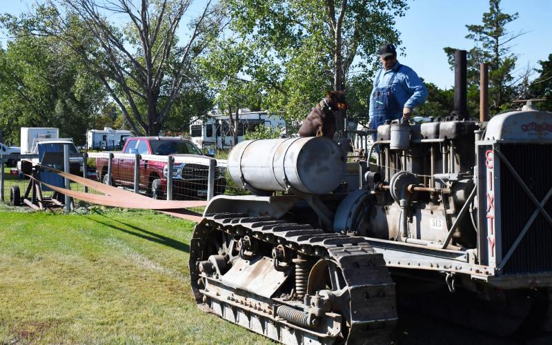 As the James Valley Threshing Show took place in Andover Sept. 6-8, various events occurred including a parade which included old agricultural machines. Here, in preparation of the parade Sept. 7, Justin Cooper and his dog DaZee from Lennox use a Baker fan to get their 1926 Caterpillar Sixty tractor in optimal condition for the parade. Reporter &amp;amp; Farmer | Brenner Cariveau