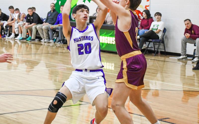 Newton Campbell (20) of Waubay/Summit drives towards the hoop during the Mustangs 67-38 victory over Langford Area Lions Feb. 2 in Waubay. Campbell finished the game with a team high 17 points in the win. Reporter &amp;amp; Farmer | Rob Dulitz