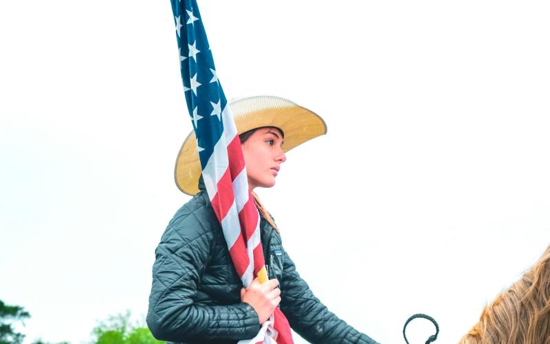 Bri White prepared for a performance of “The Star-Spangled Banner” ahead of the Waubay Roundup rodeo June 14. The first year for the annual rodeo went on despite rain earlier in the day which caused muddy arena conditions. Reporter &amp;amp; Farmer | Leyton Beardslee