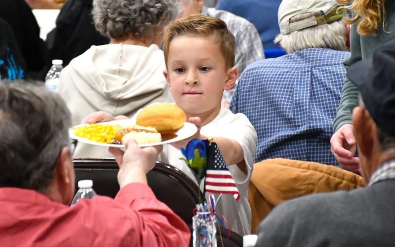 Jackson Meyer helps serve a meal during the veterans banquet at Webster Armory Nov. 8. Meyer is the son of Calvin and Bailey Meyer of Webster. Reporter &amp;amp; Farmer | Leyton Beardslee
