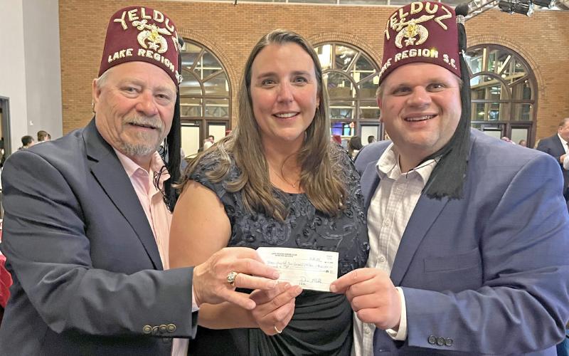 Lake Region Shrine Club members Josh Bartos, left, and Gary Fellbaum, right, present a donation check for $60,000 to Jennifer Sutch at the annual gala fundraising event for the Shriners Children’s Twin Cities hospital. Reporter &amp;amp; Farmer | Subscriber snapshots