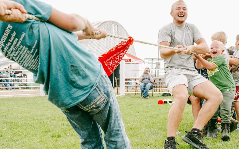 Tug of war players and Webster residents, from left, Isaac Nelson son of Jeff and Kari Nelson and five-year-old Hatcher Zubke, son of Brandon and Jess Zubke participate in the 4-H barnyard olympics organized by 4-H junior leaders at the Day County Fair Aug. 8. Nelson and Zubke’s team won the best of three rounds competition 2-1. Reporter &amp;amp; Farmer | Leyton Beardslee