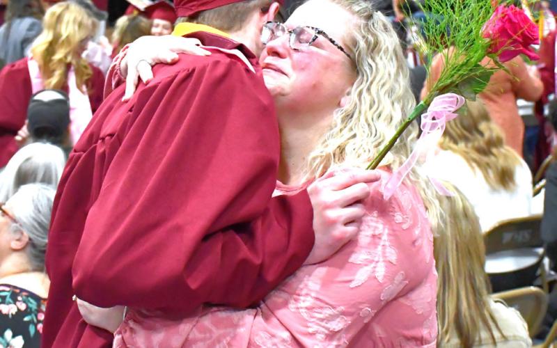 Webster Area High School held their graduation May 17 at Webster Armory. The stands and floor were packed with supporting friends and family. Angela Ayres hugs her graduate, Lukas Johnson, after he gives her a graduation flower. Reporter &amp;amp; Farmer | Connor Handrahan