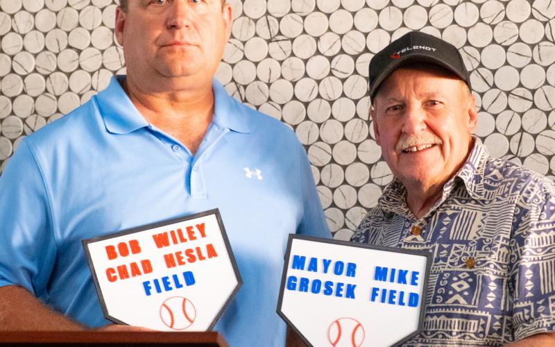Baseball complex coordinator and Webster Legion baseball coach Chad Hesla and Webster Mayor Mike Grosek received plaques Aug. 16 for baseball fields which will be named after them at Veteran’s Memorial Sports Complex in Webster. Hesla has been coaching baseball for 25 years and spent significant time fundraising and planning for the complex. Grosek coached for 20 years starting at age 17 and was mayor when the city purchased the land for the site in 2000. Reporter &amp;amp; Farmer | Leyton Beardslee