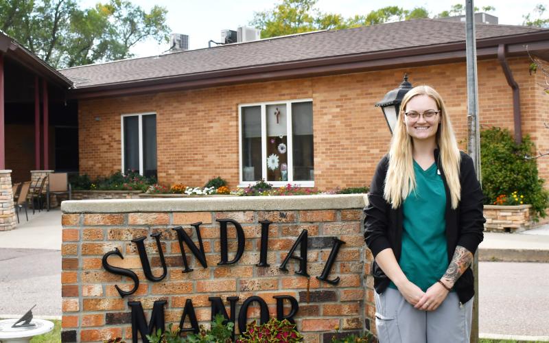 Jenaica Hunt stands next to the Sun Dial Manor sign in Bristol after becoming the new director of nursing Sept. 9. Hunt, graduated from Webster Area High School in 2015 and later went on to complete her post secondary education at Southeast Technical College in Sioux Falls in 2023. Reporter &amp;amp; Farmer | Brenner Cariveau