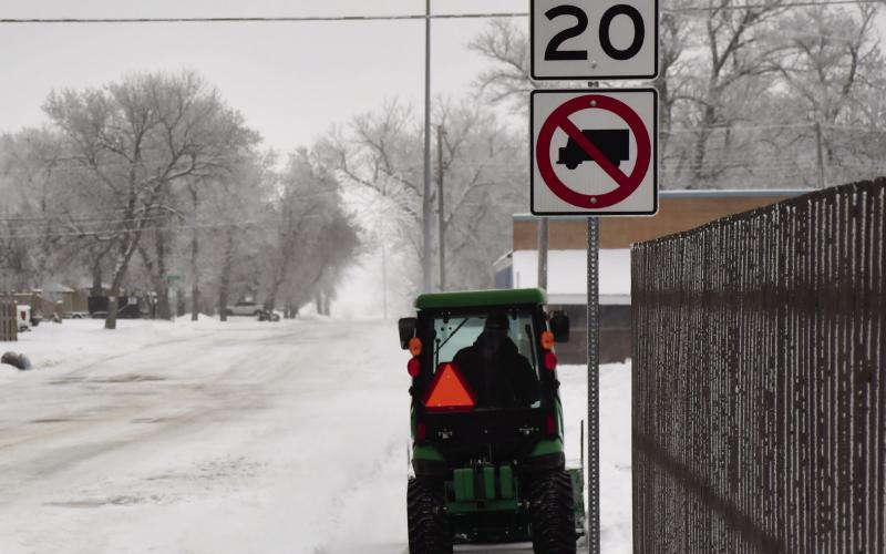 Monty Bloom removes snow with his garden tractor as he drives down W. 6th Ave. past the Main St. intersection clearing snow in his path on the sidewalks Dec. 2. Reporter &amp;amp; Farmer | Brenner Cariveau