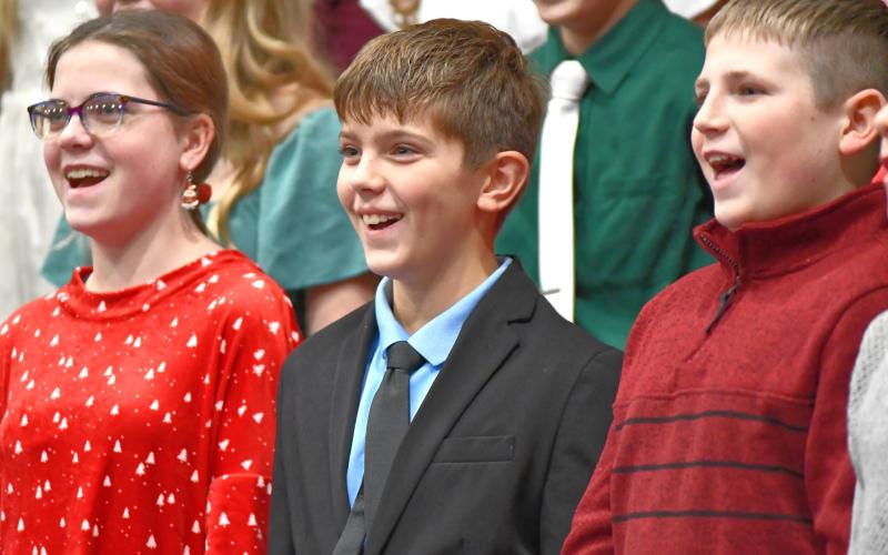 Webster Area seventh graders, from left, Cheyenne Powell, Ian Mammenga and Bryson Bloom perform in the school’s winter concert Dec. 6 at Webster Armory. The event featured choral and band performances from middle and high school students. Reporter &amp;amp; Farmer | Leyton Beardslee