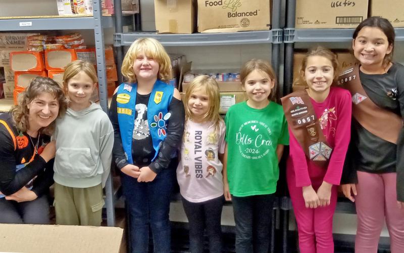 Members of Girl Scout troop #50657 of Webster spent a portion of their evening Oct. 30 packing food for the PACH (People Against Child Hunger) program at the Day County Food Pantry. Pictured from left are troop leader Jennifer Moos, Olivia Ewing, Faith Gaikowski, Arabella Ewing, Finley Marko, Aly Moos and Amara Pool. Reporter &amp;amp; Farmer | Jessica Washenberger