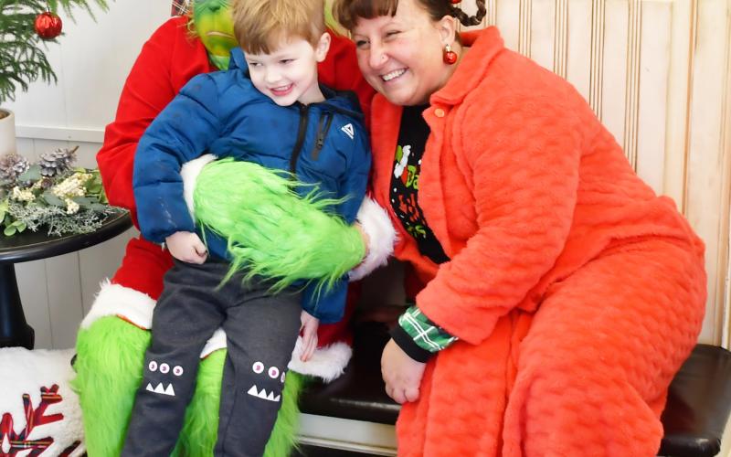 Four-year-old Griffin Lynde sits on the lap of the Grinch who made an appearance at the Brewhouse Dec. 21, along with Whoville resident Amanda Dohn. Lynde is from Webster and is the son of Matt and Megan Lynde. The event was part of a fundraising competition between the Grinch and Santa to see who could raise the most funds for six-year-old Jadyn Campbell who had open heart surgery Dec. 4.
