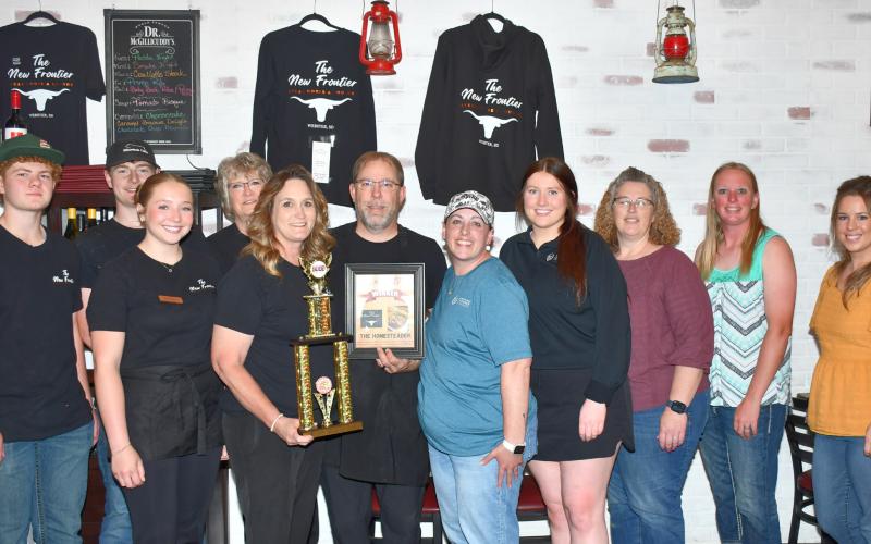 The New Frontier restaurant received their award from Webster Area Chamber of Commerce for winning the 2025 burger battle competition with their burger “The Homesteader.” In the restaurant June 10 are from left, New Frontier employees Delaney Atherton, Caleb Gaikowski, Brylie Reeves, Sharil Guthmiller, restaurant owners Kristi and Aaron Gaikowski and chamber members Alisha LaCourse, Kayla Fischer, Amy Fischer, Kelly Brandlee and Bailey Meyer. Reporter &amp;amp; Farmer | Leyton Beardslee