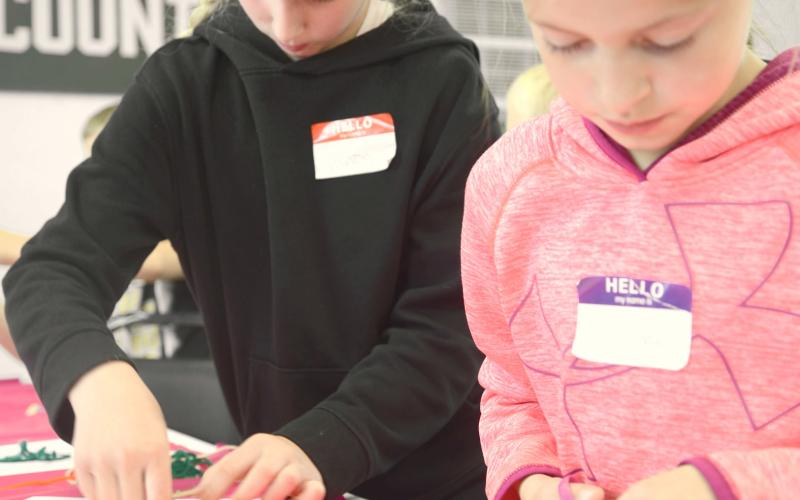 Cousins Hilton and Mallory Butler work on their yarn art at the Day County South Dakota Farmers Union Day Camp. The camp took place May 27 at the Day County Fairgrounds. Attendees learned about cooperatives along with renewable energy. Reporter &amp;amp; Farmer | Annie Witt
