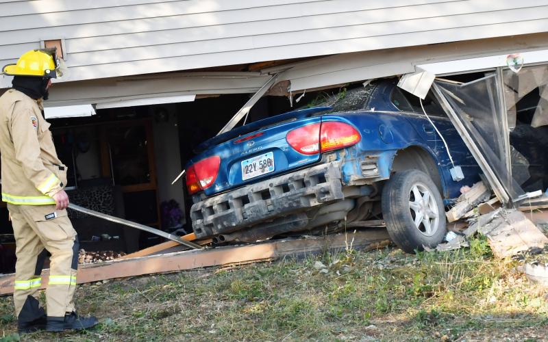A fireman looks on towards the destruction after a car crashed into a Bristol apartment’s living room Oct. 9. According to Bristol Fire Chief Preston Hansmeier, the driver sustained the only injury during the incident. No cause has been found, Hansmeier said. Reporter &amp;amp; Farmer | Brenner Cariveau