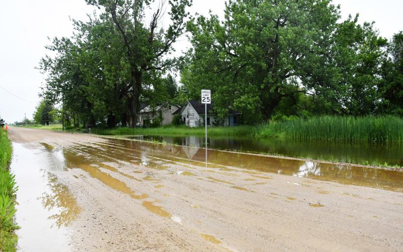 Heavy and consistent rain in the area has made many area gravel roads look like the one shown above, June 25 in Waubay near the crossing of Main Street and Jones Avenue shows rising water in the ditch flowing onto the road. Reporter &amp;amp; Farmer | Annie Witt