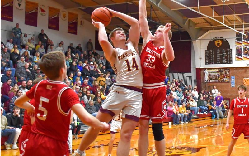 Matthew Mount (14) of Webster Area goes up for a basket while being guarded by Jaxon Zuehlke (33) of Britton-Hecla Braves during the Bearcats 78-57 region playoff win in Webster March 6. Mount tallied 18 points, five rebounds and five assists to help advance Webster to the SoDak 16. Reporter &amp;amp; Farmer | Connor Handrahan