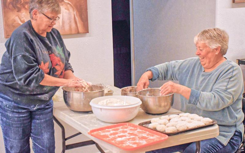 Lori Keller, left, and Sue Walter, right, help make lefse at Tabor Church, Webster lefse fundraiser Nov. 21. Keller and Walter were in charge of mixing together flour, sugar, potatoes and cream to get delicious tasting lefse. Reporter &amp;amp; Farmer | Connor Handrahan