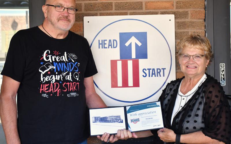 Rick Buhler, left, received the Modern Woodmen hometown hero award for his near 11 years of volunteering at the Webster NESD Head Start Center. The award was presented last week by Bernie Kurkowski, right. Buhler began volunteering at the child care non-profit in early 2015 after retiring. See full story on page 1. Reporter &amp;amp; Farmer | Leyton Beardslee