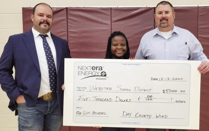 Webster Area School received a donation from Day County Wind totaling $5,000 to fund new basketball hoops and backboards for the Webster Elementary gym Dec. 12. Here from left, site manager for Day County Wind Trevor Campbell stands next to physical education and health teacher Ilienne Jaycox and k-8 principal Craig Case as they hold the check. Reporter &amp;amp; Farmer | Subscriber Snapshot