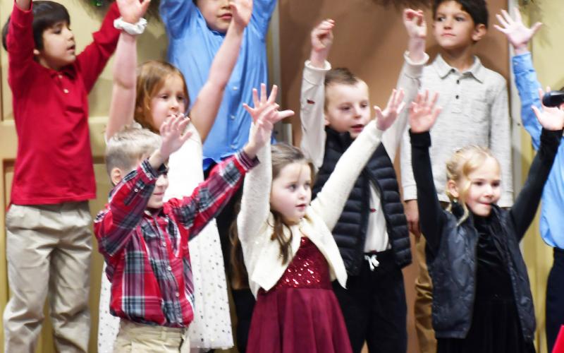 Webster Area Elementary grades k-6 participated in te winter concert at the Webster Armory Dec. 9. Here, first grade students reach towards the sky as part of their singing routine. Pictured from lef in back row are, Frank Clemente, Hunter Fellbaum, Cody Carey; second row from left, Brooklyn Bohnenkamp, Nolan Curran; first row from left Ethan Haabala, Mavis Stoebner and Arabella Ewing. Reporter &amp;amp; Farmer | Brenner Cariveau