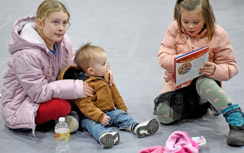 There was something for everyone at the Day County Farm &amp;amp; Home Show in Webster Jan. 25. Here, Leah Waldner, eight; Jadon Weaver, 14 months and Laura Waldner, four read books in front of the Webster Public Library booth. The Waldner sisters are the daughters of Darin and Melissa Waldner and Weaver is the son of Gary and Janna Weaver. Reporter &amp;amp; Farmer | Amanda Dulitz