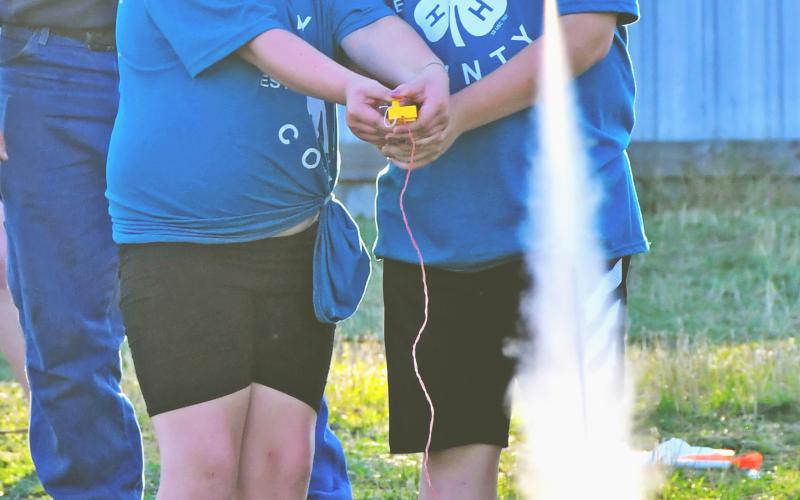 4-H siblings Holly and Hayes Zubke, eight and 11 years old respectively, work together to launch a rocket during the kickoff night at the Day County Fair Aug. 6. In the background is Connpr Fischer, who helped the youth wire up their rockets before they could be shot into the sky. The Zubke siblings are the children of Brandon and Jessica Zubke, Webster. Reporter &amp;amp; Farmer | Amanda Dulitz
