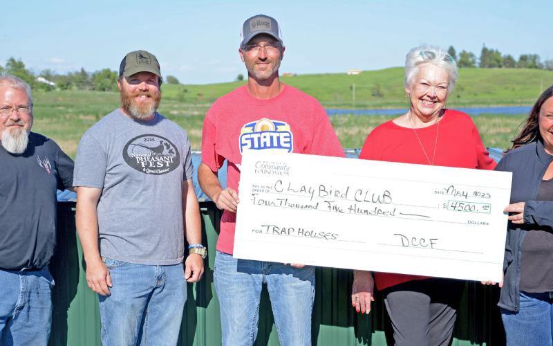 Members of the Claybird Club received a $4,500 check from Day County Community Foundation. Those funds were used to secure new trap houses at the Webster shooting facility. Pictured from left are club members Eric Kwasniewski, Nick Markl and Nick Kvernevig receiving a check from WCCF board members Rita Johnson and Amanda Dohn. Reporter &amp;amp; Farmer | Amanda Dulitz