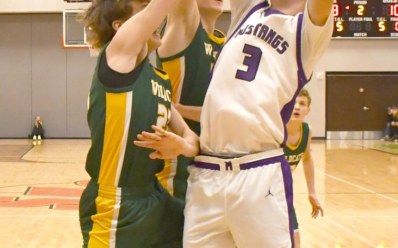 Mustangs boys faced Northwestern Wildcats March 7 in the first round match of the regional bracket. Waubay-Summit won the contest with a 51-43 score. Here, Hogan Hlavacek (3) attempts to shoot the ball amid a cluster of Northwestern defenders. Reporter &amp;amp; Farmer | Brenner Cariveau