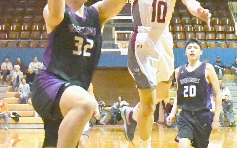 Waubay-Summit boys faced Aberdeen Christian Knights on the road with a spot in the SODAK16 up for grabs March 8 which ended in a 22-49 Mustangs loss. Here, Tripp Gaikowski (32) attempts a layup with Aberdeen Christian’s Raymond Rodriguez-Martinez (10) leaping in the air to block the shot as Newton Campell (20), trail behind. Reporter &amp;amp; Farmer | Brenner Cariveau