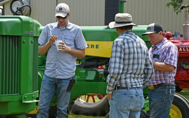 Reminiscing about the days when the antique tractors they were looking at ruled the fields and farm yards during Waubay Fun Fest’s antique tractor show are Ben Vander Schaaf, Alton, IA, David Anderson, Groton and James Jorgenson, Waubay. Reporter &amp;amp; Farmer | Amanda Dulitz