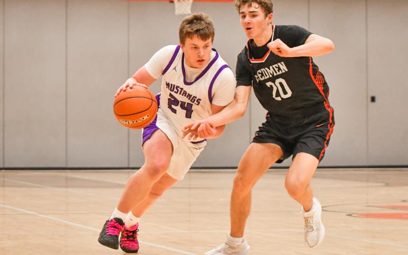 McKoy Pereboom (24) of Waubay/Summit drives the ball up court during the Mustangs narrow 45-46 loss to Sisseton Redmen Jan. 13 in Summit. Pereboom finished with three points and the Mustangs fall to a record of 3-4 on the season. Reporter &amp;amp; Farmer | Leyton Beardslee
