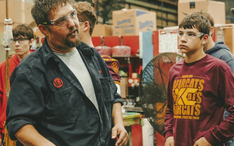 Webster Area High School freshman Mason Hauck, right, listens to Mereen-Johnson field service manager JP Vander Wilt, left, during a tour for high school students of the Mereen-Johnson’s facilities in Webster Oct. 3. Reporter &amp;amp; Farmer | Leyton Beardslee
