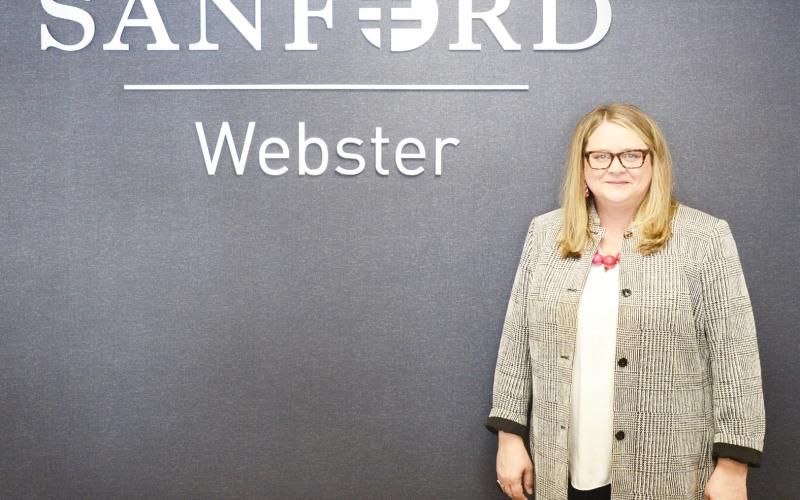 Melissa Cunningham was hired as the new CEO for Sanford Health and Bethesda Home in Webster Nov. 4. Here, Cunningham stands next to the Sanford sign in the clinic. Reporter &amp;amp; Farmer | Brenner Cariveau