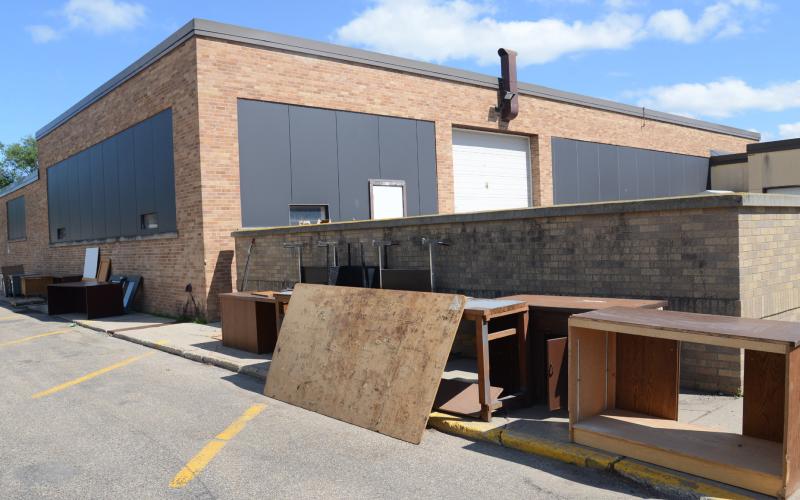 North of Webster Area High School July 17 sits surplus items as the north wing of the school will be demolished later this fall.