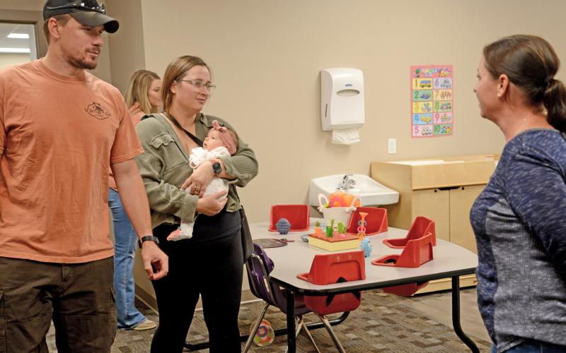 Jacob and Katlyn Lorton of Webster, along with seven-week-old daughter Maggie, listen to Knapp &amp; Play child care expert Katy Sattler explain about the infant room practices and procedures during the center’s community open house event Sept. 3. The first-time parents were planning to bring their child to the center and were there to check out the newly renovated space. Staff were prepared to begin taking in children by Sept. 8, as of press deadline. The Knapp &amp; Play Learning Center will have the capacity for