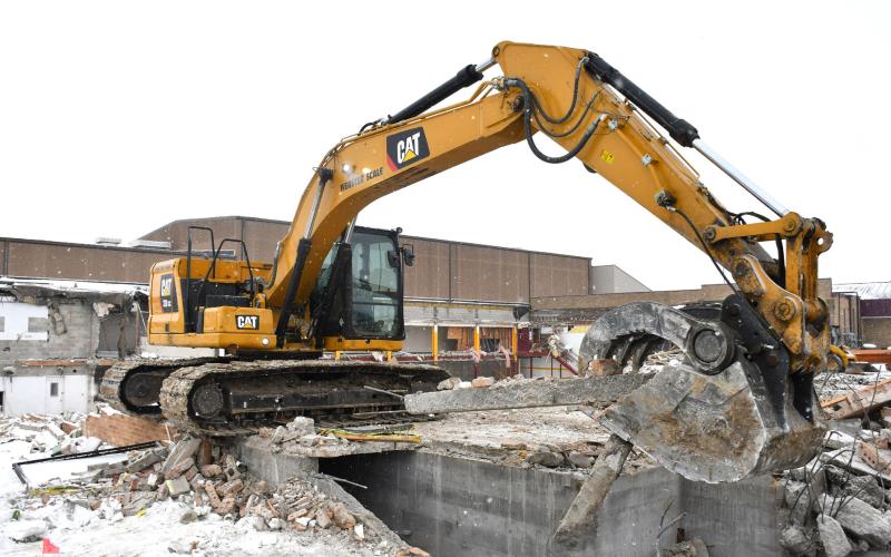 An excavator hauls rubble as the demolition of Webster Area’s 1950s wing progressed Dec. 11. Superintendent Jim Block estimated the demolition and rubble sorting would be completed within two to three weeks. Significant completion of the project which includes leveling the space to become a parking lot and installation of two new vestibule doors is set for July. Reporter &amp;amp; Farmer | Leyton Beardslee