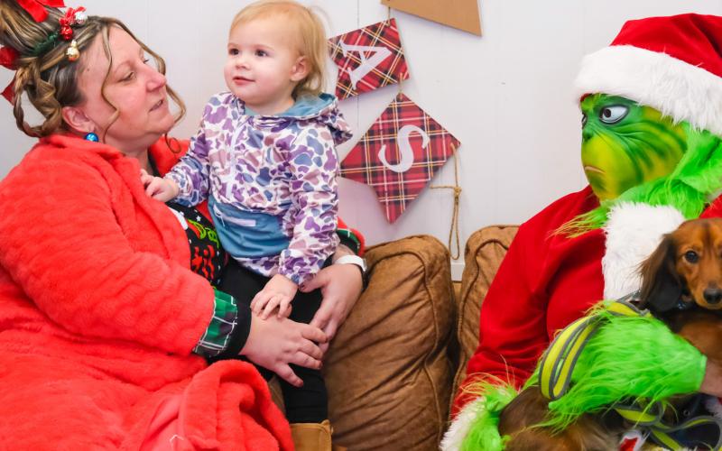 Piper Spears, age two, meets Cindy Lou Who played by Amanda Dohn, the Grinch, played by Tori Hoffer Dec. 13 at Brewhouse in Webster. The meet-and-greet was part of a fundraiser to cover medical expenses for a local child who experienced a medical trauma. Spears is the daughter of Megan and John Spears from Webster. Reporter &amp;amp; Farmer | Leyton Beardslee