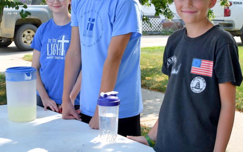 Helping members of the community beat the heat on Main Street of Webster July 25 were Mila and Colby Hoffman and Oakley Ascher. The trio spent the afternoon making and selling lemonade for some end of summer spending cash. Reporter &amp;amp; Farmer | Annie Witt