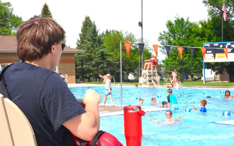 Thomas Kuecker, now with five summers of lifeguard experience, watches over swimmers in the afternoon sun on the first day of open swim at Webster Aquatic Center, June 1. Kuecker has made two rescues in his career, but said a typical day is spent enforcing the pool rules. Reporter &amp;amp; Farmer | Timothy Gibson