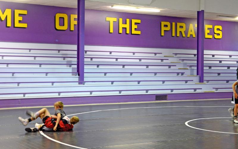 Some Sniper Wrestling Academy wrestlers practice in the former Bristol School gym. Pictured from left are Cruz Praszincki and Oliver Umlauf working on technique during a practice while Braxten Sombke and Wesley Storts get situated with coach Chad Umlauf watching. Reporter &amp;amp; Farmer | Annie Witt