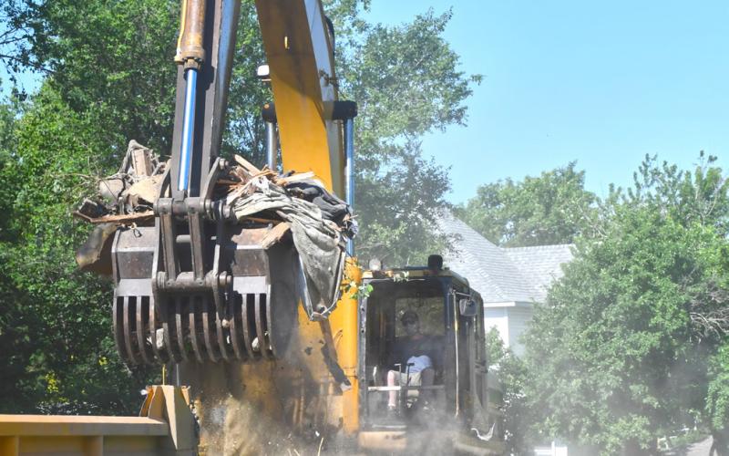 Rubble from the demolition of a house located at 1106 Main St., Webster is loaded into a dump truck June 24. The demolition comes after the city seized possession of the property in August 2024 and the building caught fire in September of the same year. An investigation was launched to determine if the cause of the fire was arson but the states attorney ruled there was not enough evidence to pursue charges and the building was demolished. Reporter &amp;amp; Farmer | Leyton Beardslee