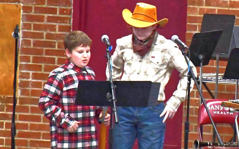 From left, Dylan Ellis and Cruz Shafer introduce the story and next song for Webster Area’s spring music concert April 20. Elementary students put on a western music concert and dressed up in proper uniform for the special occasion. Reporter &amp;amp; Farmer | Connor Handrahan