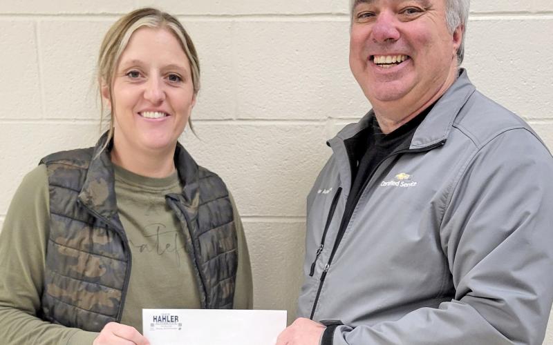 Webster Area School nurse Heather Gaikowski receives a check presented by Loren Schoenbeck on behalf of Dave Hahler Automotive in Webster Nov. 26. The $2,100 donation will to towards assisting students in need of winter clothing. Reporter &amp;amp; Farmer | Subscriber snapshot