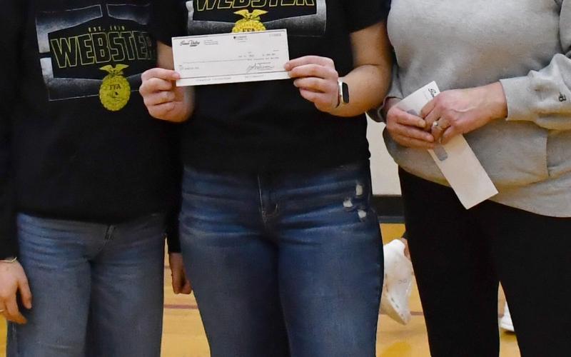 During FFA week at Webster Area High School Sioux Valley Coop made a $1,000 donation to FFA Feb 21. Here from left, Jaidryn Rice and Norah Zubke receive the check from Cheryl Premus. Reporter &amp;amp; Farmer | Brenner Cariveau