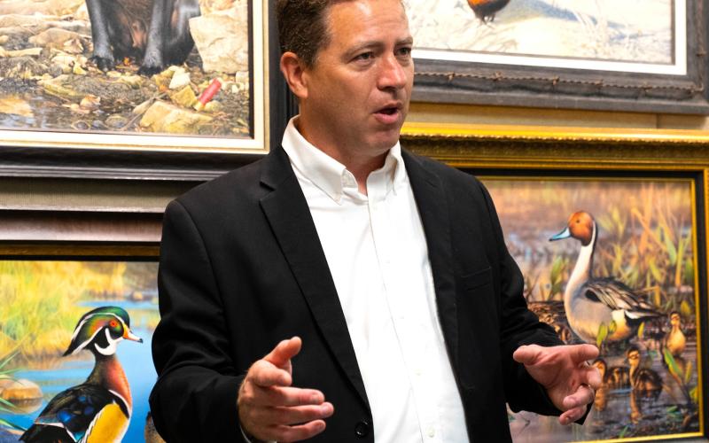 Adam Grimm, surrounded by his artwork, talks to attendees of his hometown celebration in Wallace Aug. 9 about winning the 2024-2025 Federal Duck Stamp Art Contest. This was Grimm’s third time winning the contest but first time holding a celebration in Wallace which included bouncehouses, educational games, coloring contests and displays of Grimm’s art. Reporter &amp;amp; Farmer | Leyton Beardslee