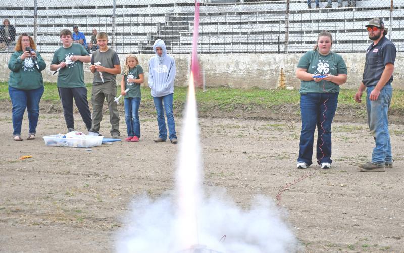 Fifteen-year-old 4-Her Kelsey Fischer launches the rocket she made Aug. 7 at the Day County Fairground. Fischer and her brother Connor Fischer both watch with anticipation as the small rocket quickly launches into the sky leaving a small plume of smoke behind. In the back, from left, Amy Fischer, Carson Fischer, Aiden Gaikowski, Kori Gaikowski and Taylor Anderson. Reporter &amp;amp; Farmer | Brenner Cariveau